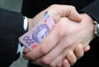 В Киеве двух госисполнителей управления юстиции разоблачили во взяточничестве